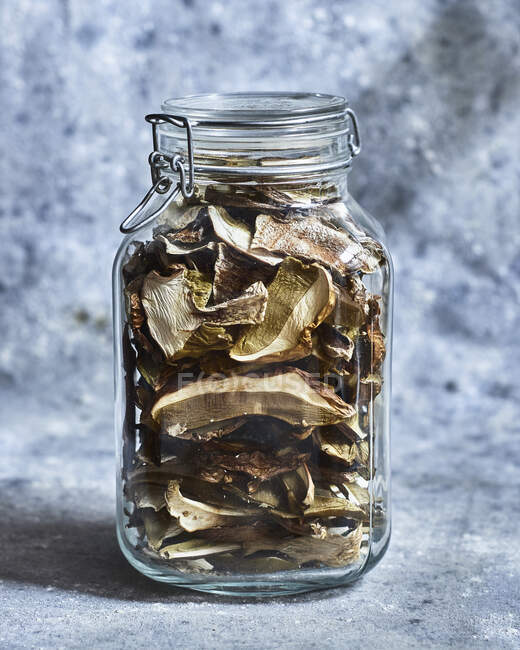 Dried mushrooms in a flip-top jar — Stock Photo