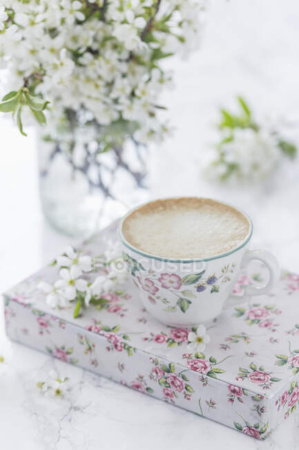 Cup of coffee and cherry blossom — Stock Photo