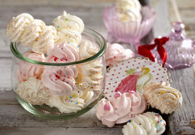Various cute meringues with colorful sprinkles — Stock Photo