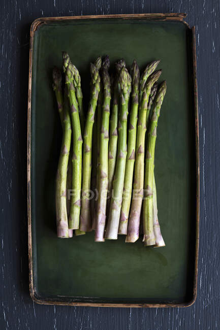 Fresh green asparagus on a black background — Stock Photo