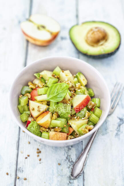 Salad with apples, celery, avocado and walnuts — Stock Photo
