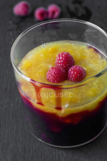 Cherry porridge with mango, peach, and pomegranate in glass — Stock Photo