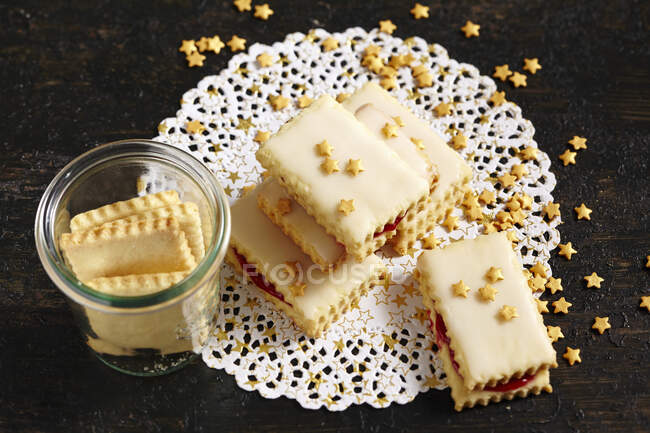 Delicious biscuits with icing and stars sprinkles — Stock Photo