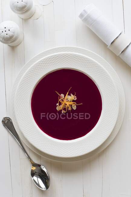 Borscht, beetroot soup with almond flakes and orange zest — Stock Photo