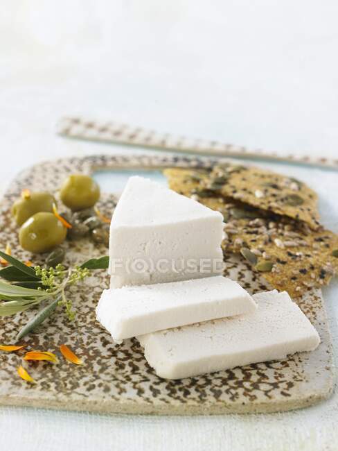 Vegan macadamia nut and cashew nut cheese with crackers and olives — Stock Photo