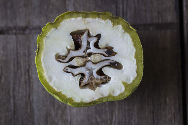 A cross-section of a green walnut (seen from above) — Stock Photo