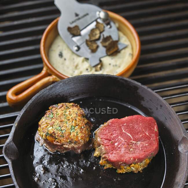 Beef steak with a cheese and herb crust and truffles polenta — Stock Photo