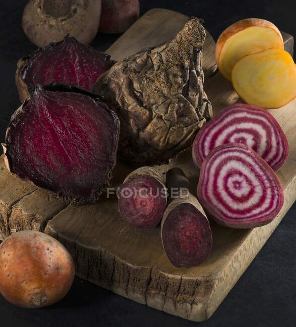 Red, yellow and striped beetroot on a wooden board — Stock Photo