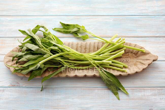 Water spinach in a wooden bowl — Stock Photo