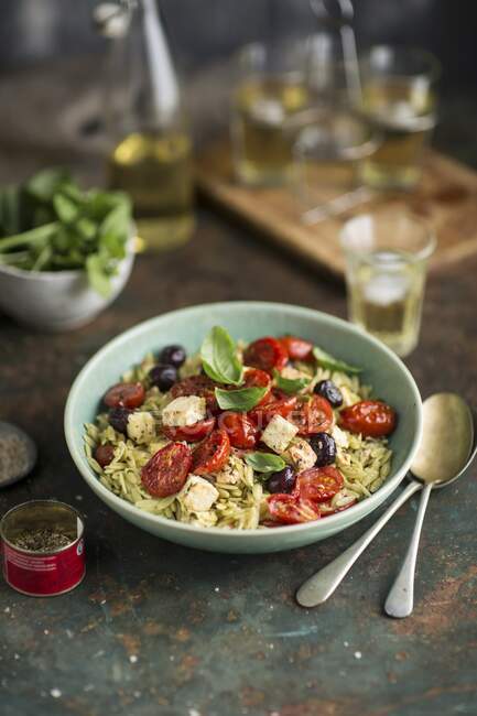 Rosemary pasta with fried tomatoes, feta and olives — Stock Photo