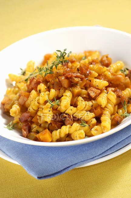 Torchietti pasta with pumpkin, bacon and herbs — Stock Photo