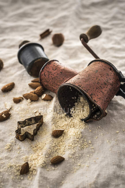An old almond mill with whole and ground almonds — Stock Photo