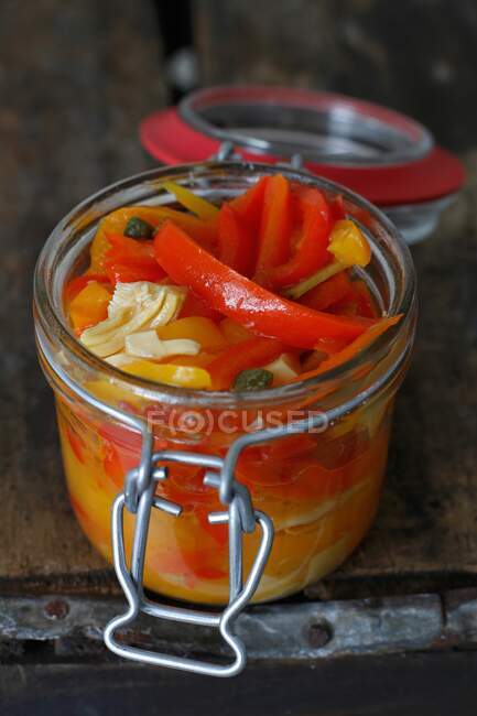Italian Pickled Peppers in a Jar on a rustic wood background — Stock Photo