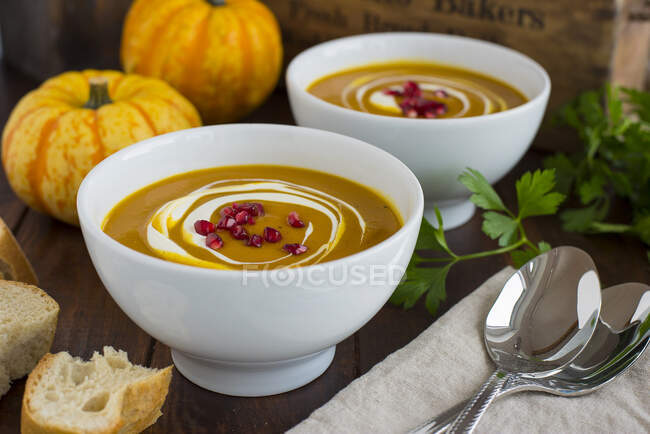 Cream of pumpkin soup with pomegranate seeds — Stock Photo