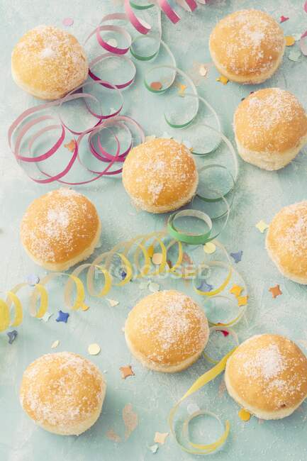 Doughnuts with carnival decorations — Stock Photo