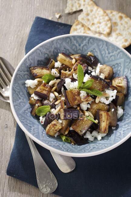 Aubergine and feta cheese salad with pine nuts — Stock Photo