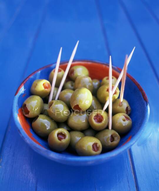Stuffed olives with toothpicks — Stock Photo