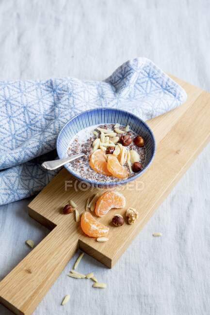 Flaxseed pudding with nuts and tangerines — Stock Photo