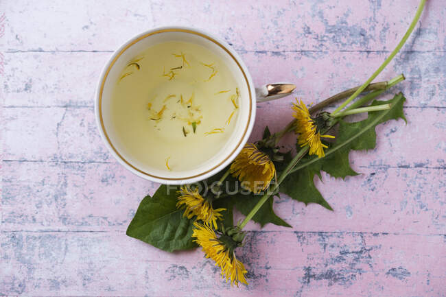 Té de hierbas con flores de limón y tilo sobre un fondo de madera - foto de stock