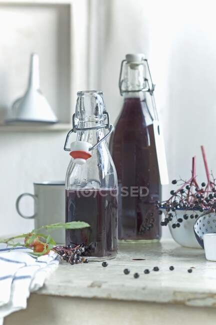 Homemade elderberry juice in bottles — Stock Photo