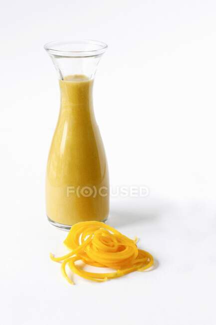 Butternut soup in a glass bottle with butternut noodles and space for text — Stock Photo