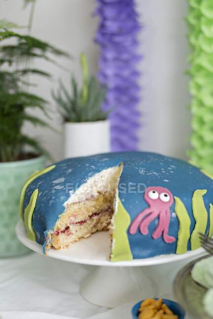 Торт с кокосовым кремом и украшением из кальмаров для морской тематической вечеринки — стоковое фото
