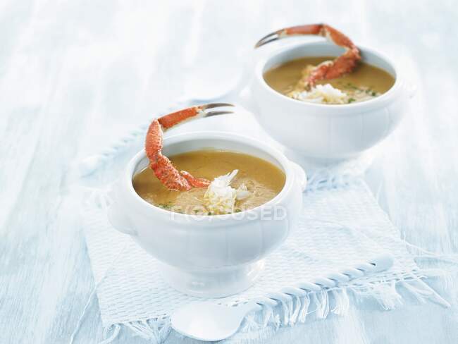 Creamy crab soup in white bowls — Stock Photo