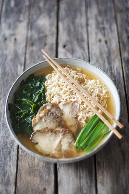 Ramen with pork and algae in bowl with chopsticks — Stock Photo