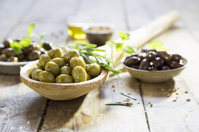 Various marinated olives with herbs — Stock Photo