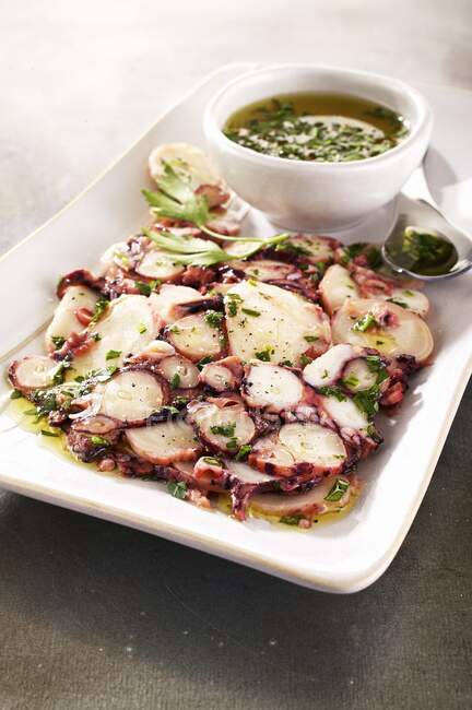 Carpaccio of octopus with herb oil — Stock Photo