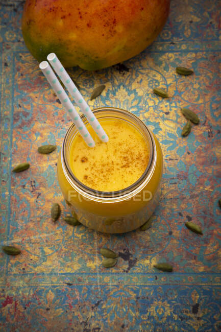 A mango lassi in a jar with a straw — Stock Photo