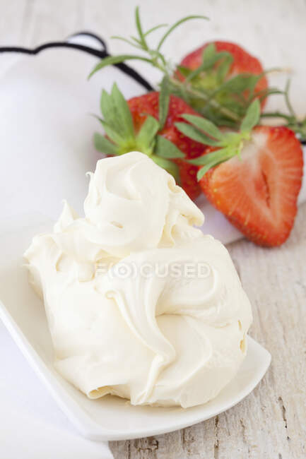 Mini plate with cream, strawberries and rosemary on table — Stock Photo