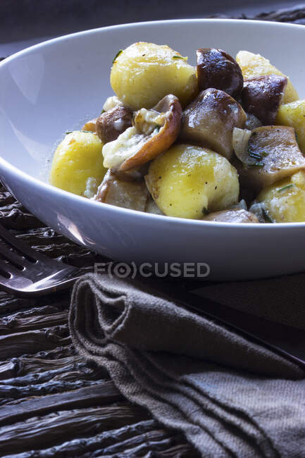 Gnocchi with porcini mushrooms and rosemary — Stock Photo
