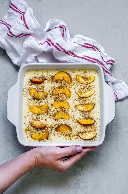 Raw pie with peaches on a concrete background — Stock Photo