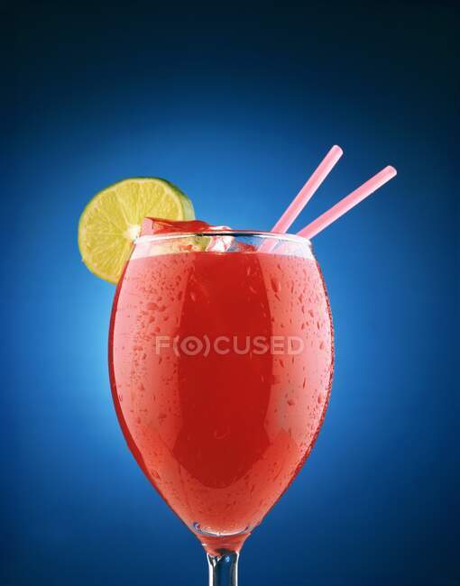 Bloody Mary cocktail with lime and straws on blue Background — Stock Photo