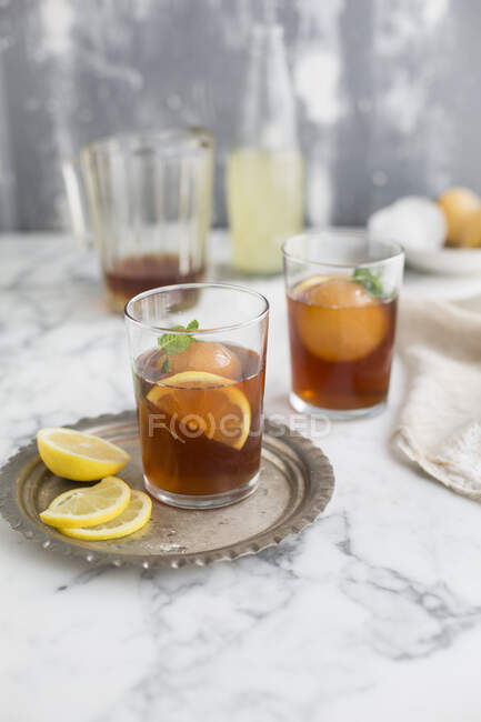 Glass of lemon juice with ice and mint on table — Stock Photo