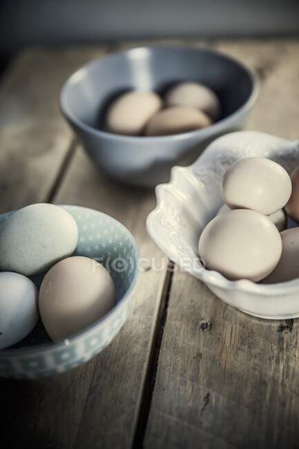 Various eggs in ceramic bowls, close up shot — Stock Photo