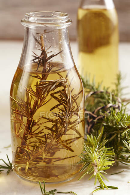 Aceto di rosmarino fatto in casa in una bottiglia di vetro — Foto stock