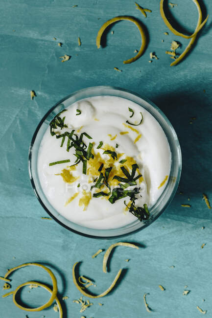 Lemon cream with lemon peel and basil — Stock Photo