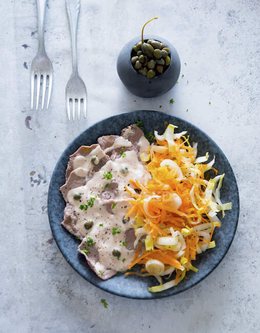 Vitello tonnato with a carrot and chicory salad — Stock Photo