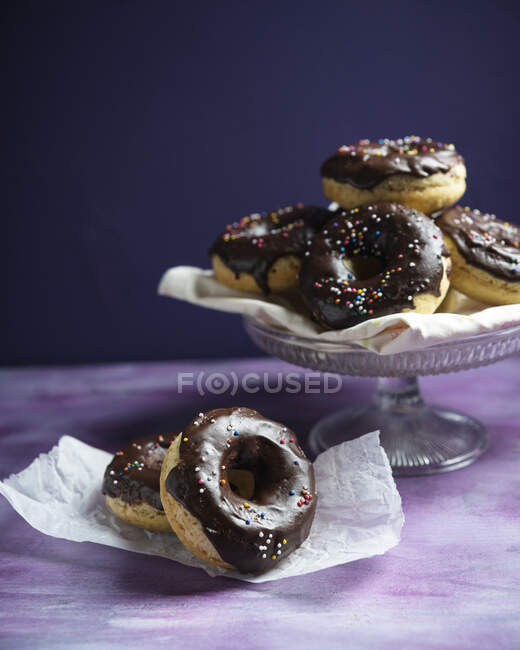 Vegan doughnuts with a cocoa and coconut glaze and sugar pearls — Stock Photo