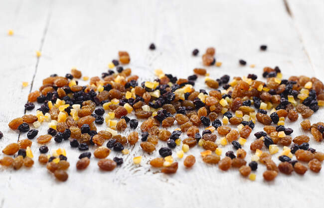Dried fruit mixture on a white wooden background — Stock Photo
