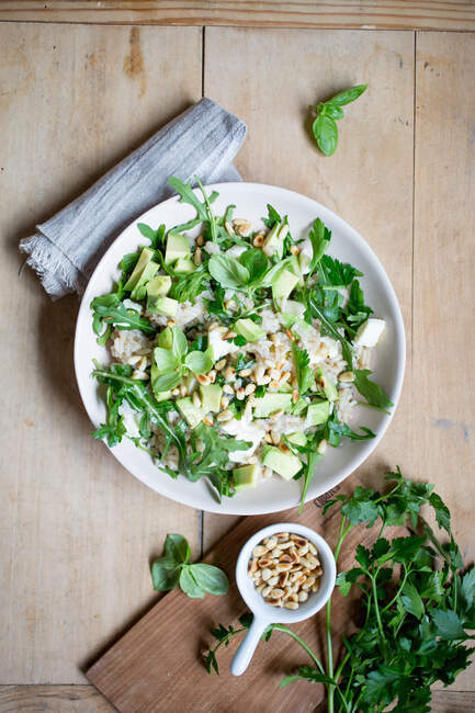 Rice salad with herbs, avocado, feta cheese and pine nuts — Stock Photo