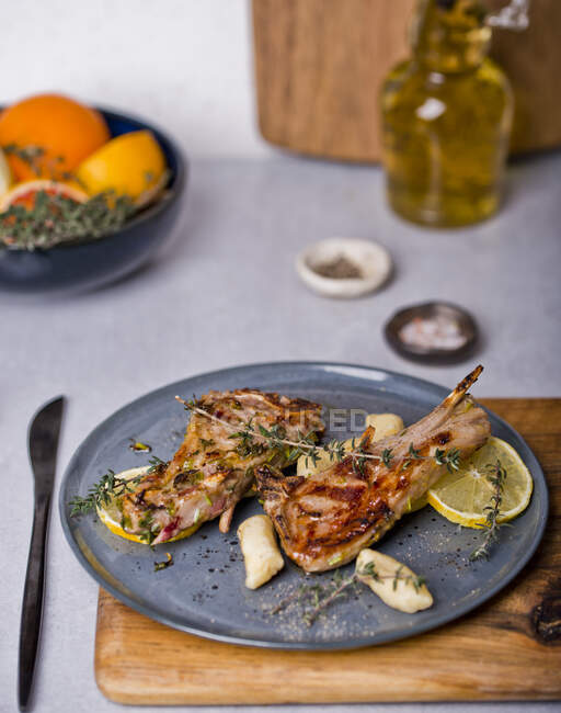 Grilled lamb chops with thyme and lemon slices — Stock Photo