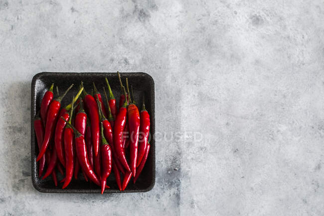 Red chili peppers in a small bowl — Stock Photo