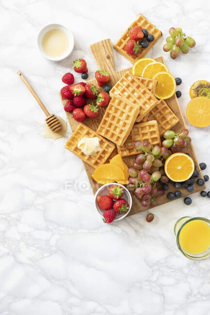 Waffles with fruits and orange juice — Stock Photo