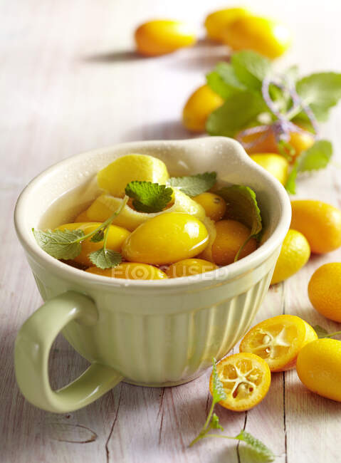 Homemade kumquat vinegar with lemon balm — Stock Photo