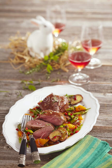 Lamb steaks with a bean and pepper medley and potatoes — Stock Photo