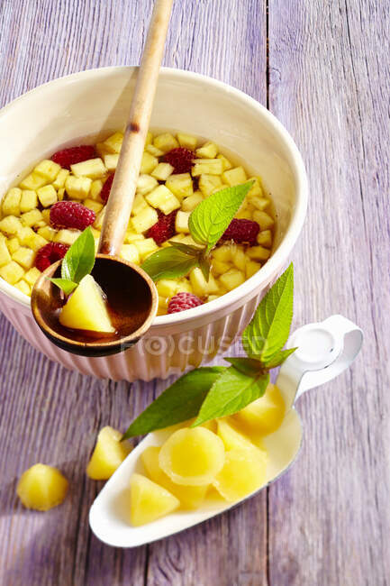 Pineapple punch with raspberries and pineapple pieces — Stock Photo