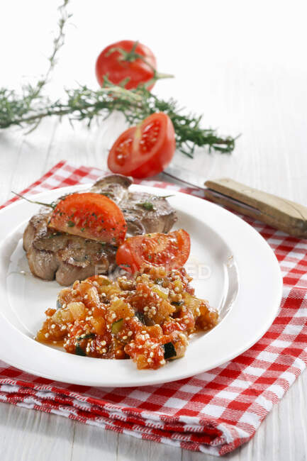 Pork necks with quinoa and tomato chutney — Stock Photo